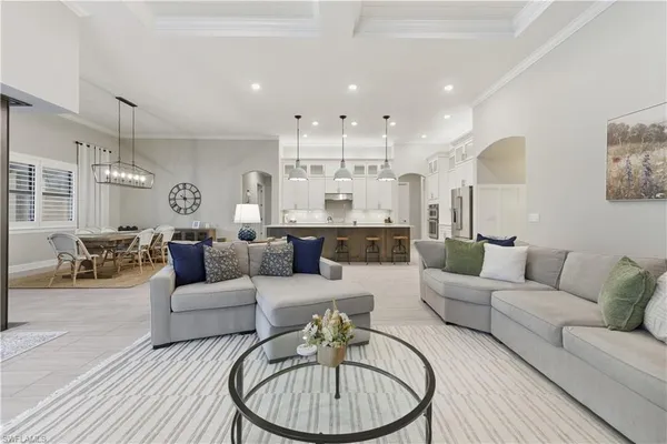 a living room with furniture and a chandelier