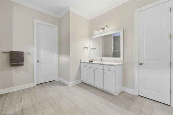 a bathroom with a sink vanity and mirror