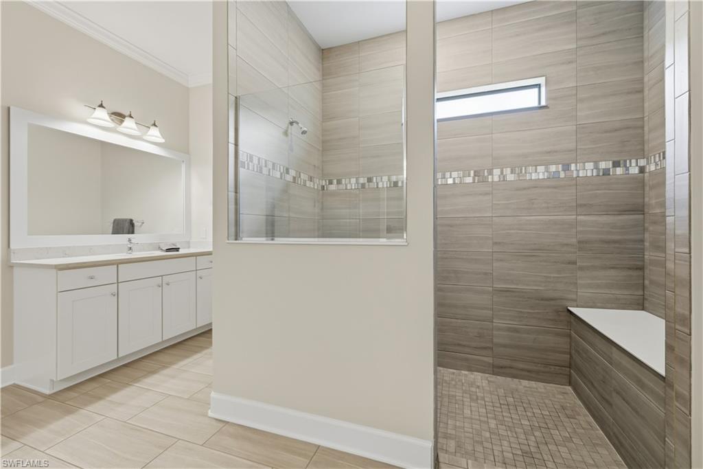 19074 Elston Way Estero, FL 33928 - Photo 35 of 50 a bathroom with a sink a toilet a mirror and shower