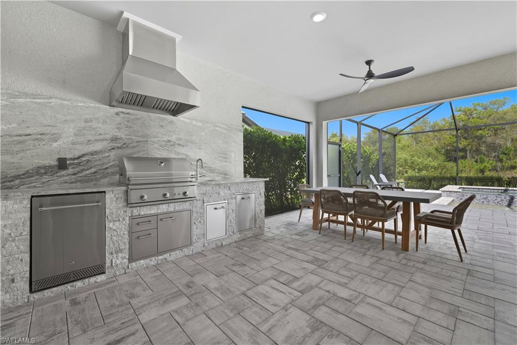 19074 Elston Way Estero, FL 33928 - Photo 38 of 50 a kitchen with stainless steel appliances granite countertop a stove a sink and a microwave