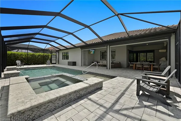 a swimming pool with outdoor seating