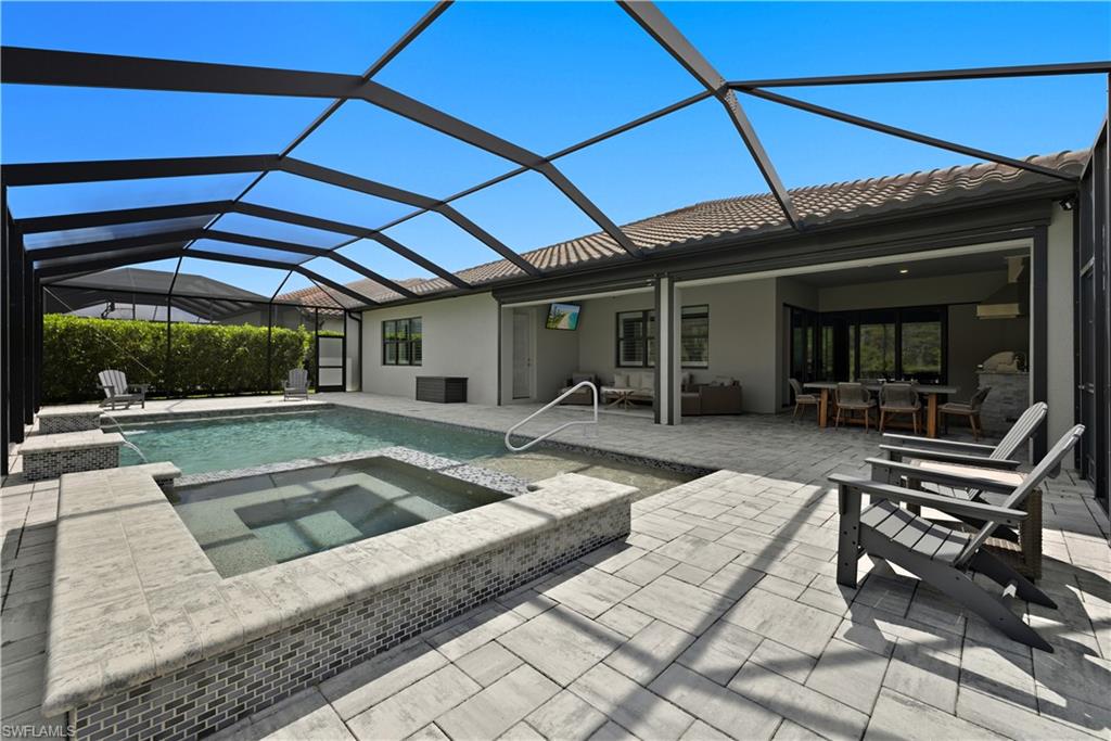 19074 Elston Way Estero, FL 33928 - Photo 40 of 50 a swimming pool with outdoor seating