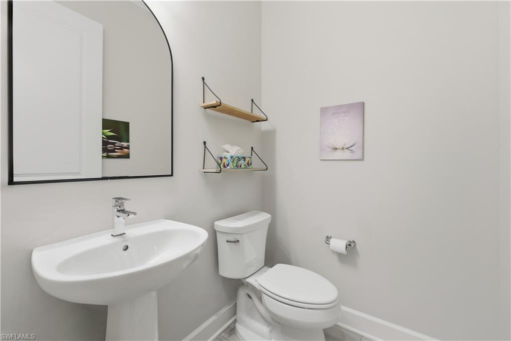 19074 Elston Way Estero, FL 33928 - Photo 4 of 50 a bathroom with a toilet sink and mirror