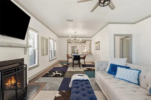 a living room with furniture fireplace and flat screen tv