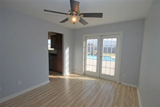 wooden floor in an empty room with a window