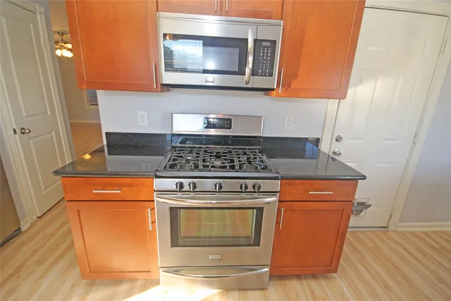 a kitchen with a microwave and cabinets