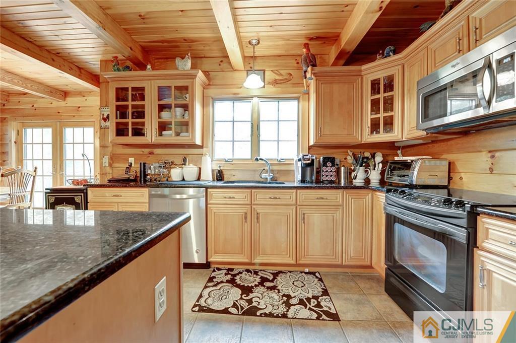 4 Hampton Road Pittstown, NJ 08867 - Photo 11 of 25 a kitchen with stainless steel appliances granite countertop a stove a sink and a microwave