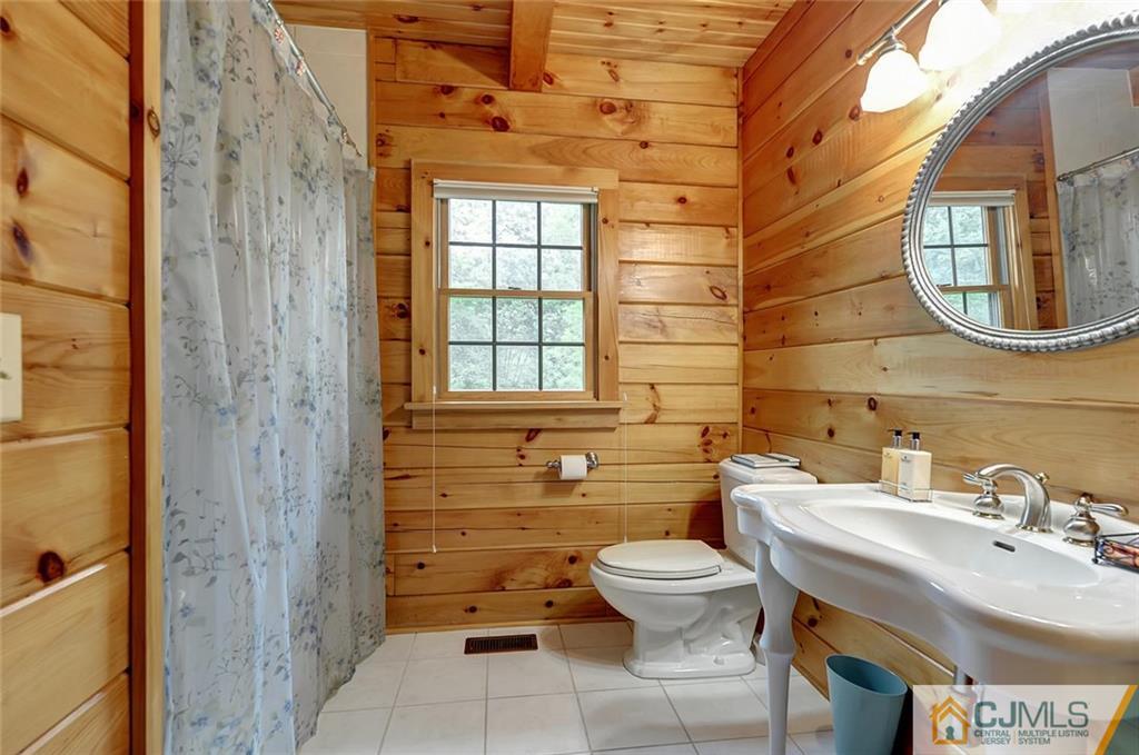 4 Hampton Road Pittstown, NJ 08867 - Photo 13 of 25 a bathroom with a toilet a sink and mirror