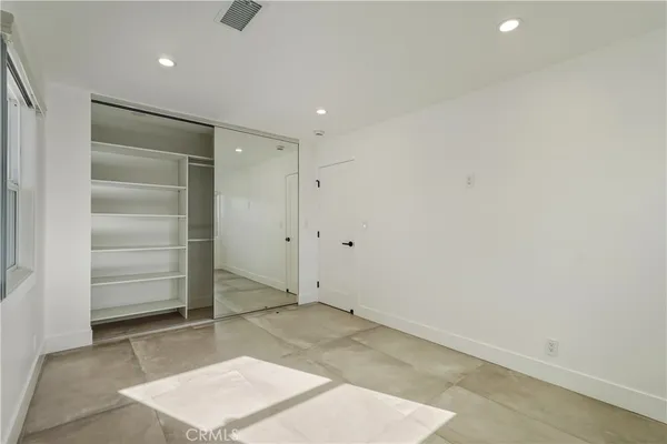 a bathroom with a sink a toilet a mirror and shower