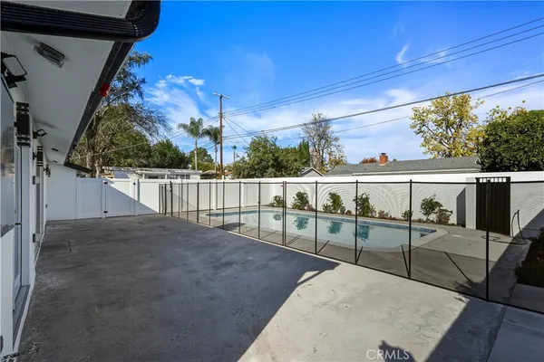 a view of a kitchen with refrigerator and more cabinets