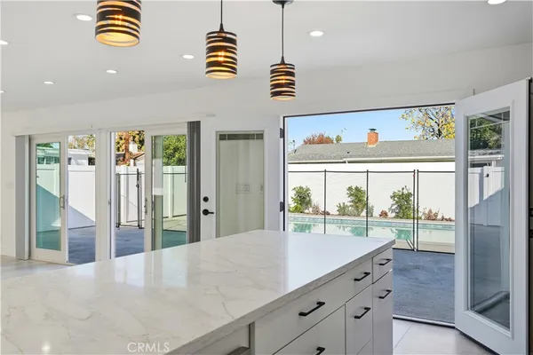 a view of a kitchen with furniture and wooden floor