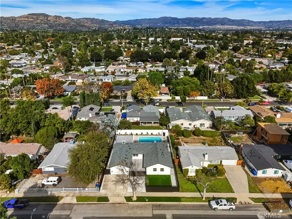 a large kitchen with stainless steel appliances kitchen island granite countertop a refrigerator and a stove top oven