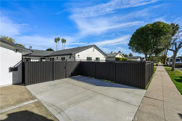 a large kitchen with stainless steel appliances granite countertop a sink a stove and a refrigerator