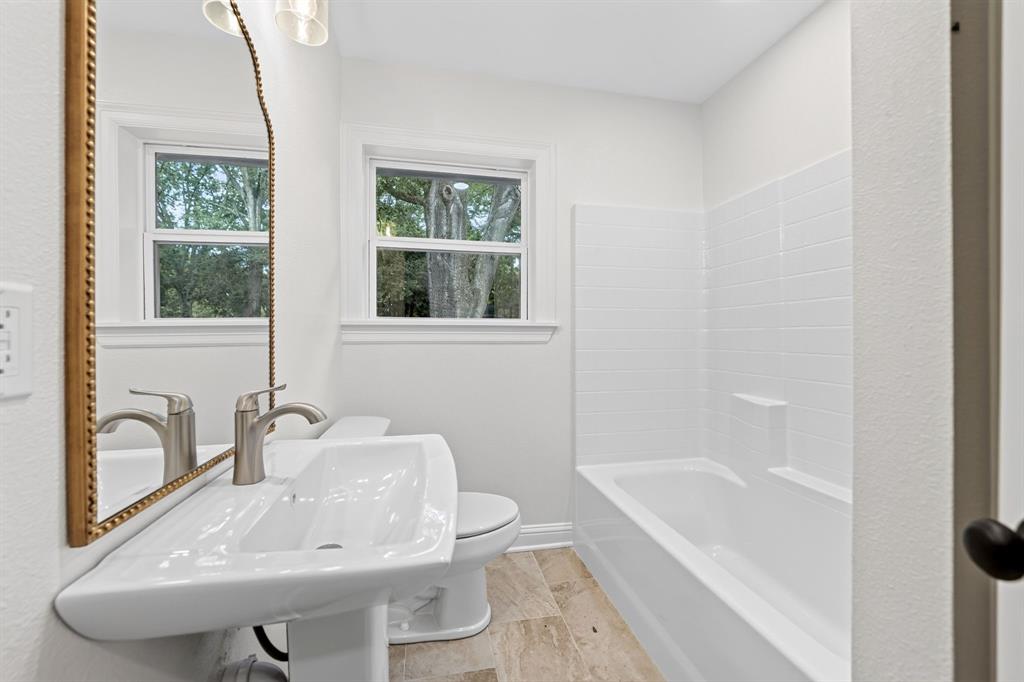 608 Bunny Rabbit Road Athens, TX 75751 - Photo 21 of 33 Bathroom featuring a pedestal sink with a brushed nickel faucet, a framed mirror, and a window