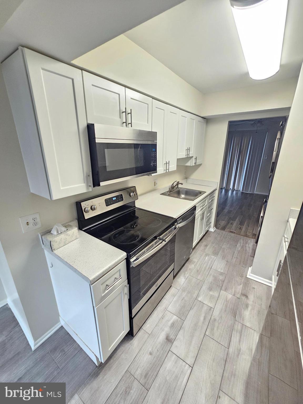 17445 Hoskinson Road Poolesville, MD 20837 - Photo 7 of 37 a kitchen with a stove and a microwave