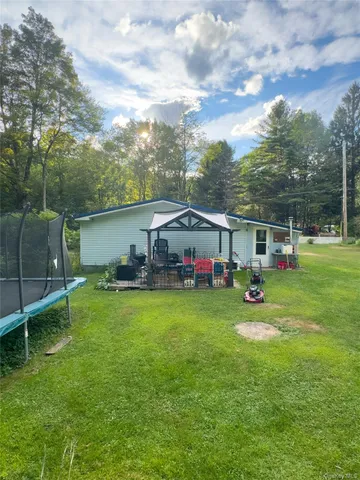 a view of a house with backyard and porch