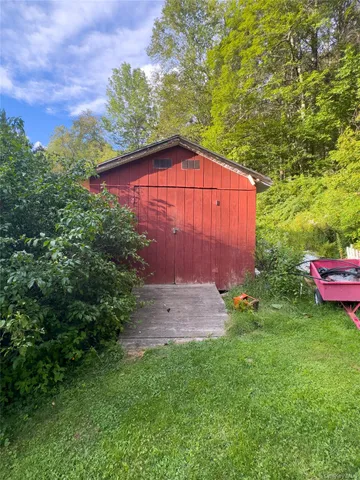 a view of backyard with outdoor seating and green space