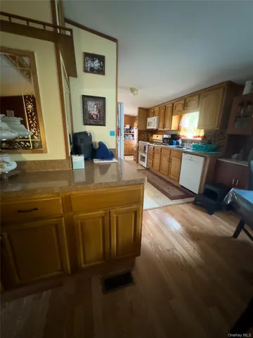 a view of kitchen with furniture and wooden floor