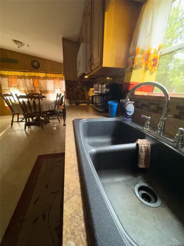 a kitchen with a sink and a stove next to a window