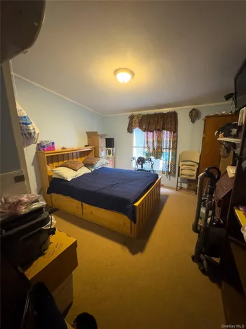 a bedroom with furniture and a flat screen tv