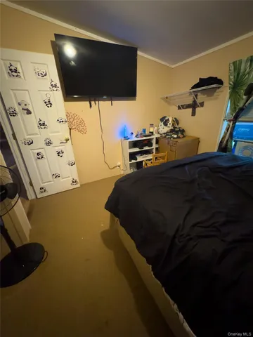 a bedroom with a bed and flat screen tv