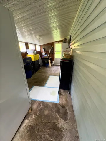 a view of a hallway with seating space