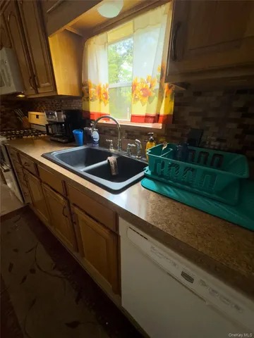 a kitchen with a sink and large window