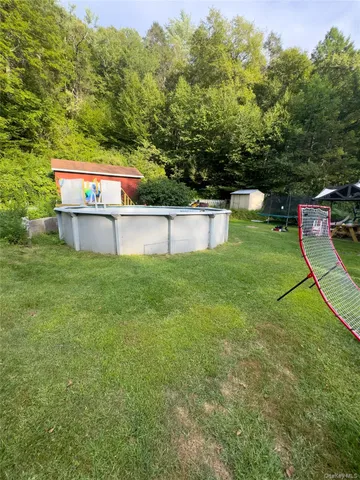 a view of a swimming pool with a yard