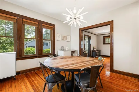 a view of a dining room with furniture window and wooden floor