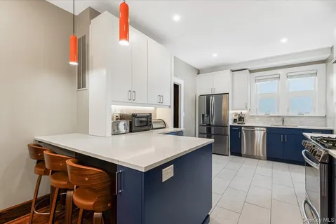 a kitchen with a refrigerator a stove top oven a sink and dishwasher