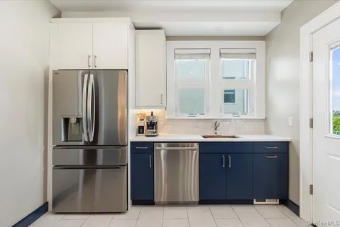 a kitchen with a refrigerator and a sink