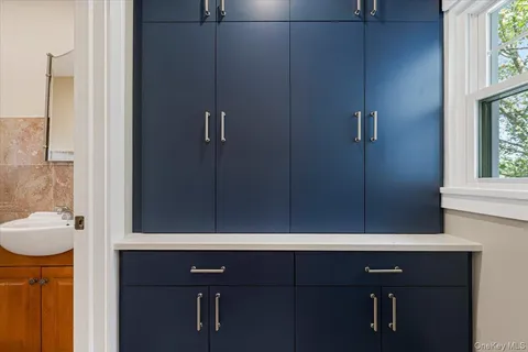 a bathroom with a sink vanity and a mirror
