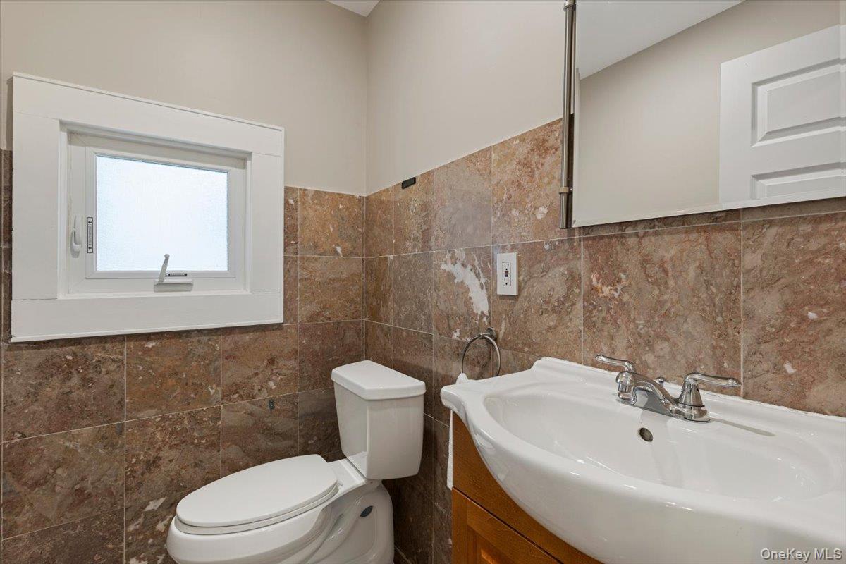 13 Harrison Street Tuckahoe, NY 10707 - Photo 24 of 44 a bathroom with a sink a toilet and a mirror