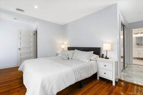 a bedroom with a bed and a night stand