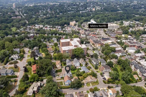 an aerial view of residential houses with city view