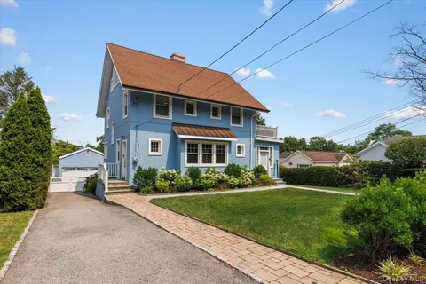 a front view of house with yard and green space
