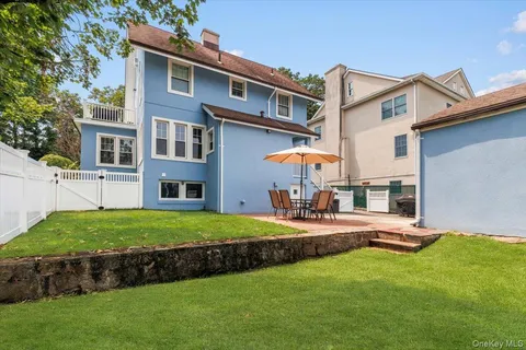 a view of a house with a yard and sitting area