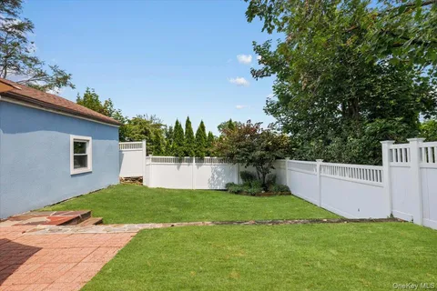 a view of a house with a yard and sitting area