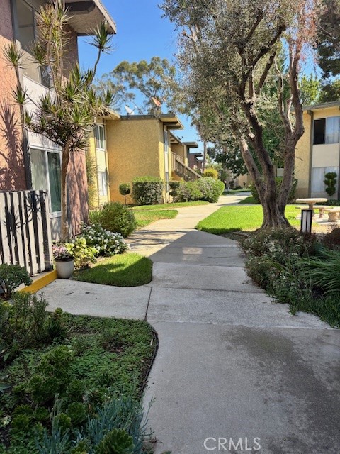 23302 Marigold Avenue, Unit Y204 Torrance, CA 90502 - Photo 1 of 16 a view of a house with garden and tree s