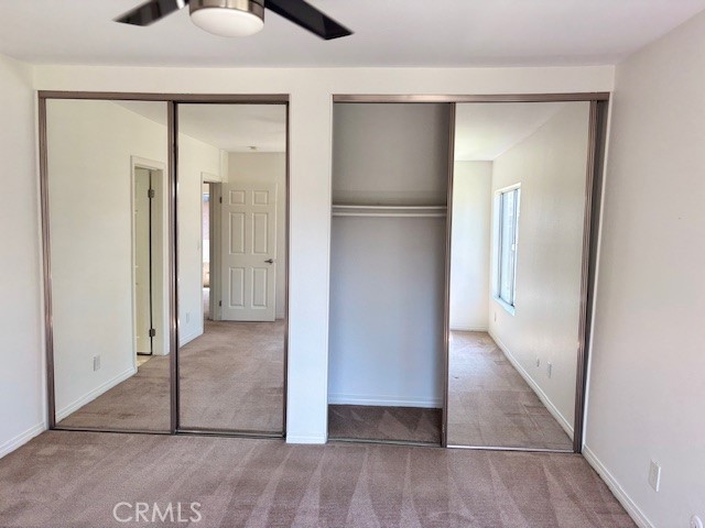 23302 Marigold Avenue, Unit Y204 Torrance, CA 90502 - Photo 10 of 16 a view of a livingroom with wooden floor and a ceiling fan
