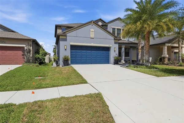 a front view of a house with a yard and garage