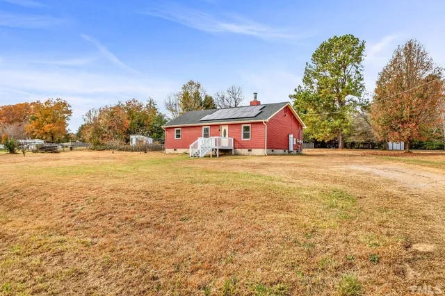 a view of a house with yard and lake view