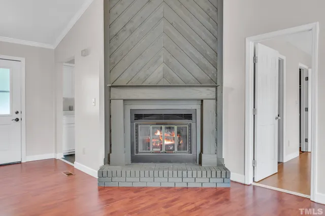 a view of an empty room window and fire place