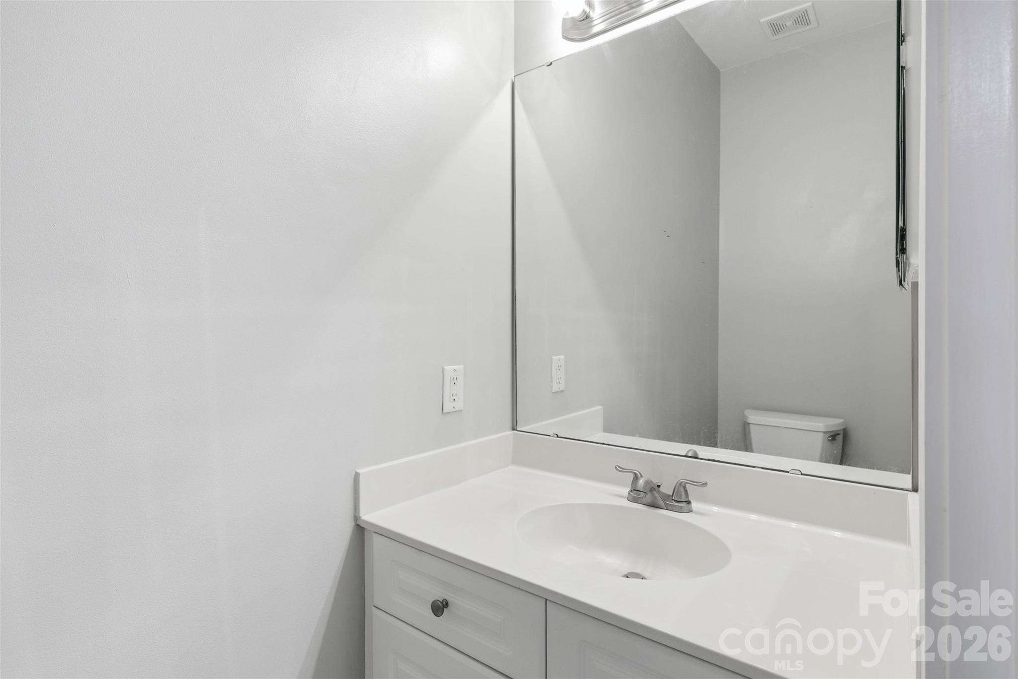 9054 Meadow Vista Road Charlotte, NC 28213 - Photo 16 of 30 a bathroom with a sink and a mirror
