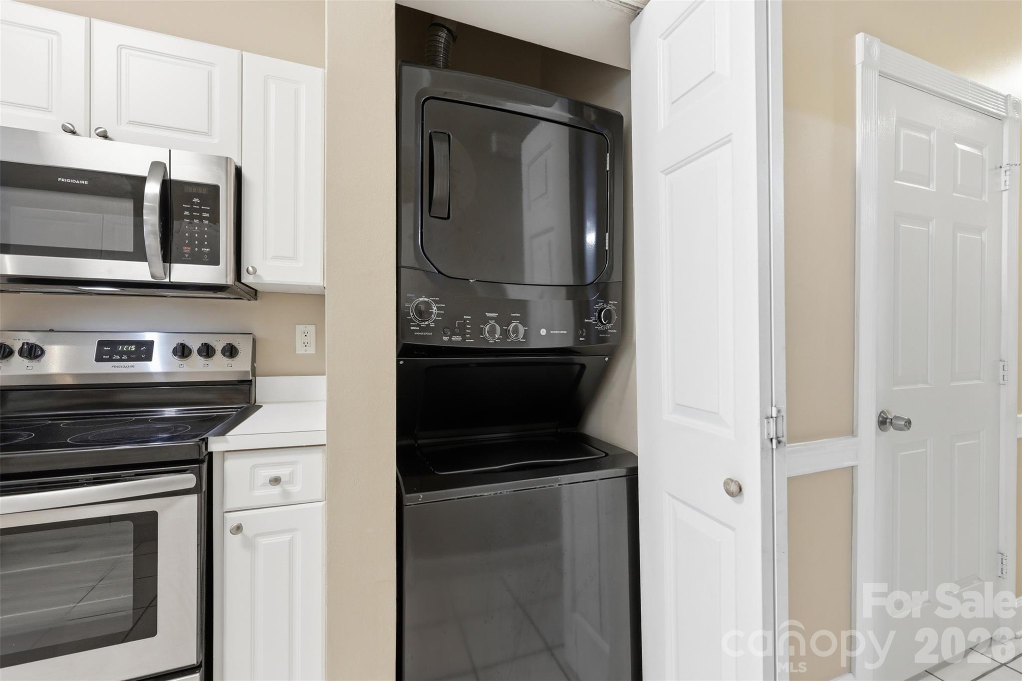 9054 Meadow Vista Road Charlotte, NC 28213 - Photo 23 of 30 a kitchen with stainless steel appliances granite countertop a stove and a microwave