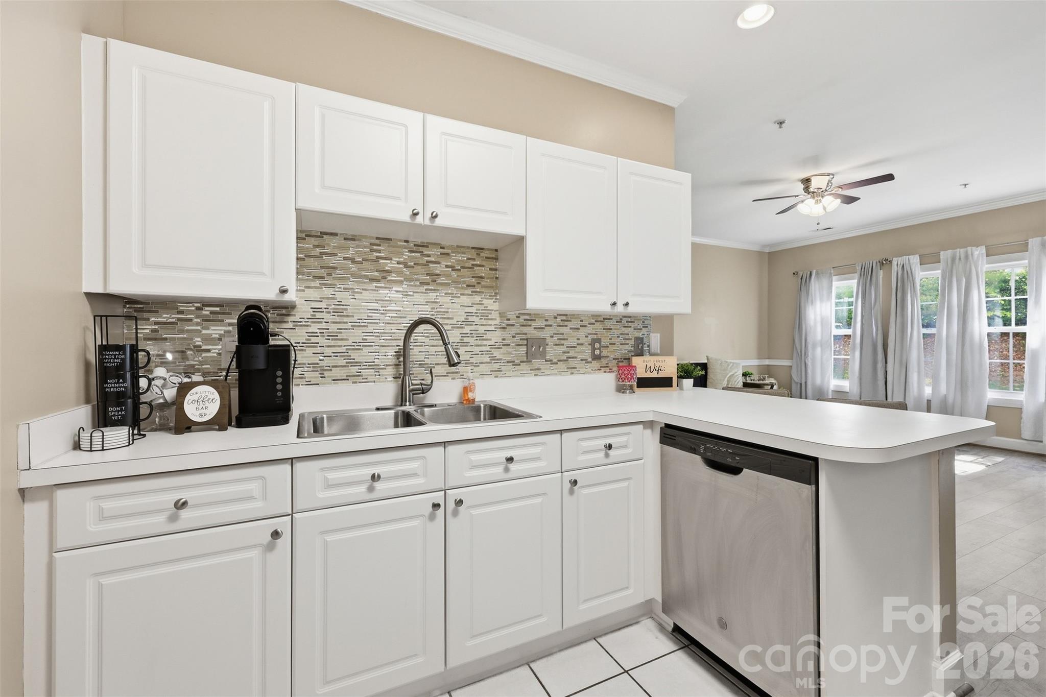 9054 Meadow Vista Road Charlotte, NC 28213 - Photo 6 of 30 a kitchen with white cabinets sink and white appliances