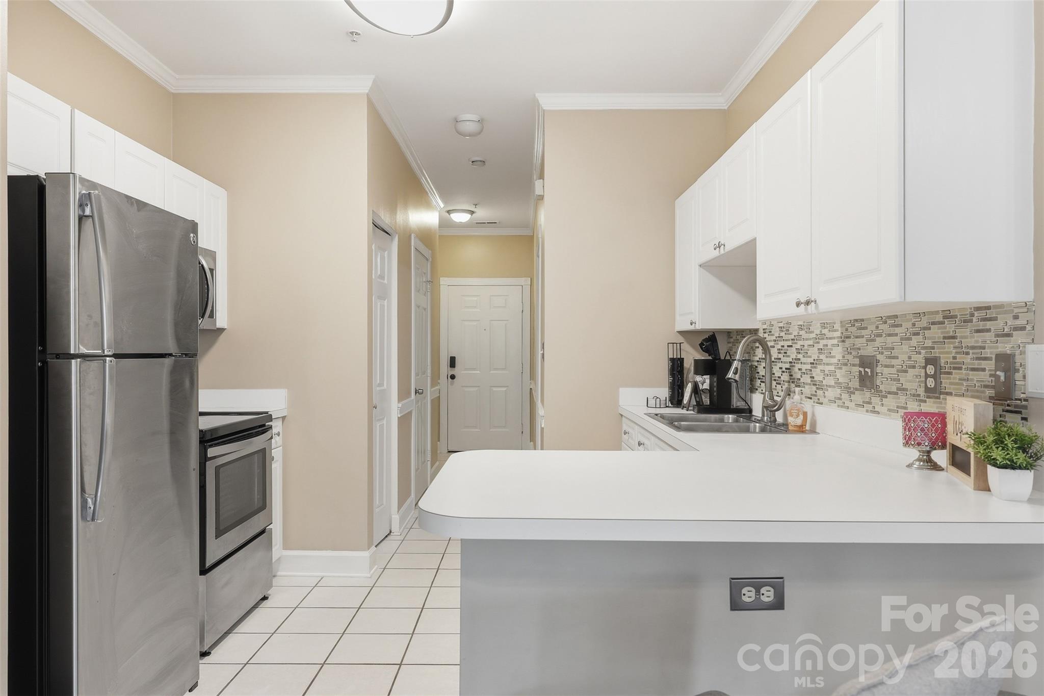 9054 Meadow Vista Road Charlotte, NC 28213 - Photo 10 of 30 a kitchen with stainless steel appliances a refrigerator sink and cabinets