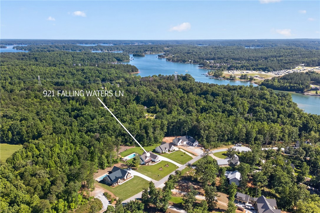 921 Falling Waters Lane Seneca, SC 29672 - Photo 42 of 46 An aerial panorama reveals a waterfront community with homes nestled among mature trees and a glistening lake.