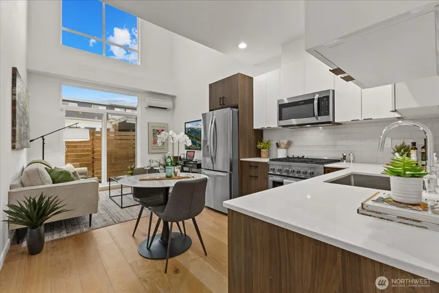 a kitchen with a table chairs refrigerator and microwave