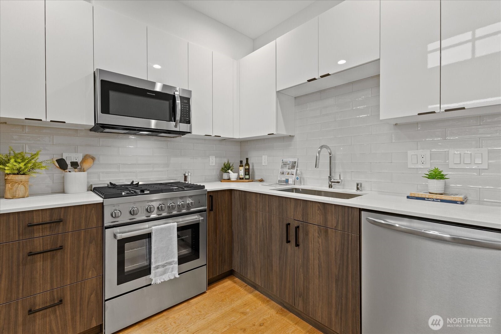 5439 California Avenue Southwest, Unit H Seattle, WA 98136 - Photo 11 of 23 a kitchen with stainless steel appliances granite countertop a sink a stove top oven and cabinetry
